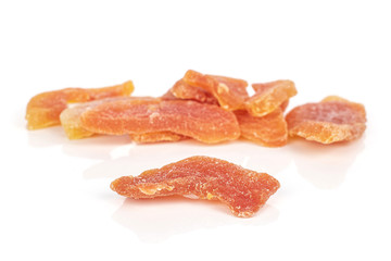 Lot of whole dried orange papaya piece front focus isolated on white background