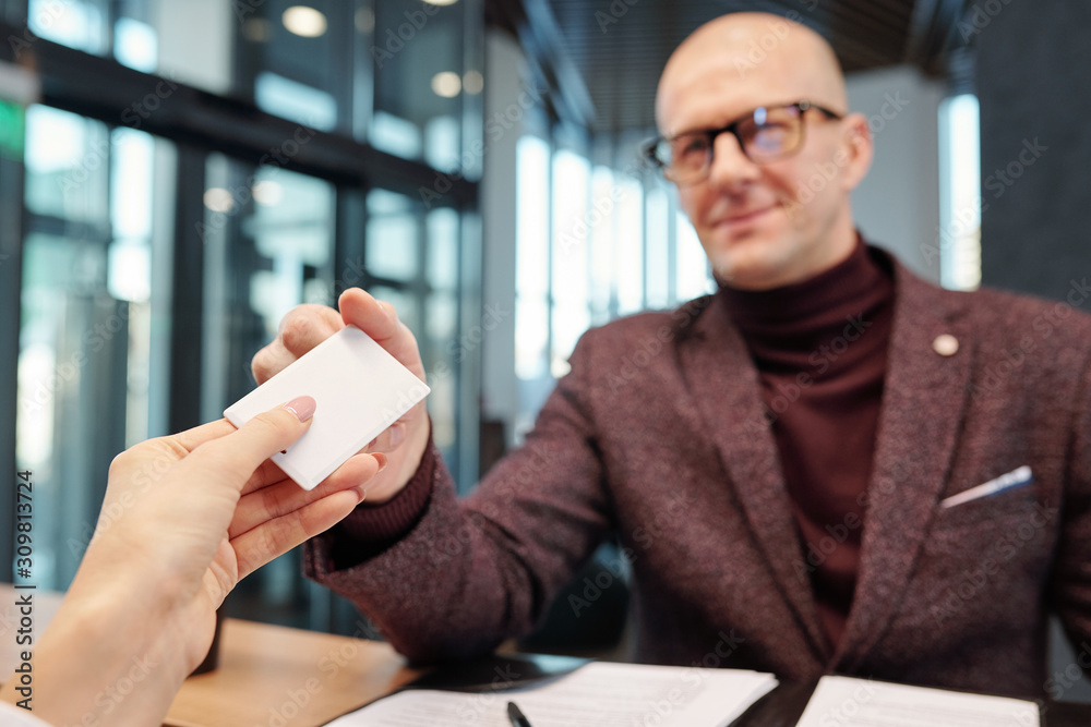Poster hand of businessman taking card from empty hotel room at reception counter
