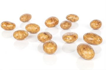 Lot of whole sweet tiramisu brown almond nut isolated on white background