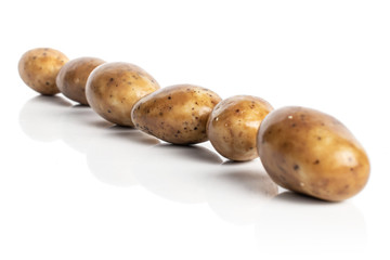 Group of six whole tiramisu brown almond nut diagonal isolated on white background