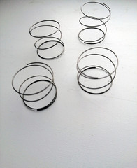 metal springs lying on a white surface