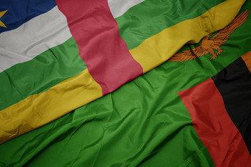waving colorful flag of zambia and national flag of central african republic.