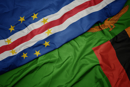 waving colorful flag of zambia and national flag of cape verde.