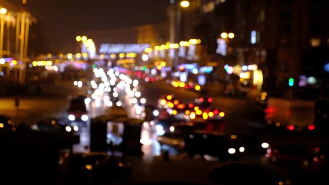 Defocused night city car traffic lights. Color blurred bokeh of moving transport and typical city view