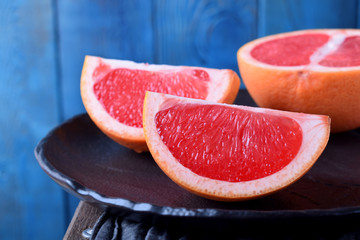 Slices of red grapefruit on the black plate