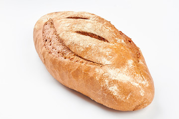 Whole loaf of a crispy bread on white background. Delicious rye bread. Homemade bread recipe.