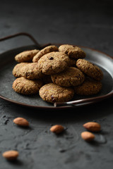 Gluten free sugar free vegan sweets. Homemade almond bites in vintage metal tray on black background