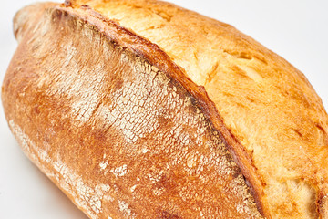 Rye bread loaf on white background. Fresh crusty bread. Healthy homemade food.