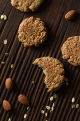Homemade cookies. Healthy breakfast oatmeal cookies with almonds on ribbed oak board