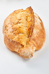 Fresh and crusty bread on white background. Fresh rye bread loaf. How to make crispy bread.