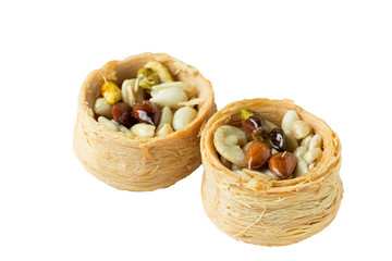 Traditional arabic dessert Kunafa with honey and nuts, Isolated on a white background,  selective focus.