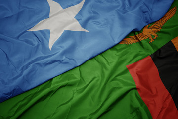 waving colorful flag of zambia and national flag of somalia.