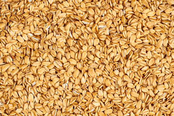 Oat flakes background. Oatmeal flakes texture. Food concept.