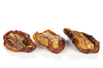 Group of three whole dried red tomato piece isolated on white background