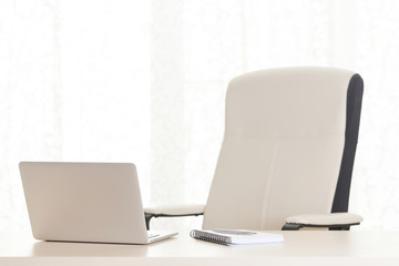 Home office workplace with laptop and supplies