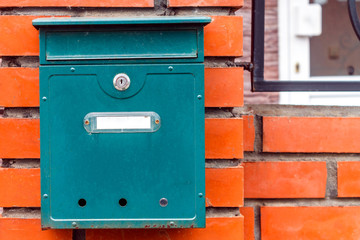 A beautiful mailbox hangs waiting for newspapers, parcels and letters.