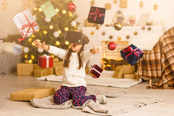 Obraz na płótnie Canvas little girl in virtual 3D glasses at christmas at home