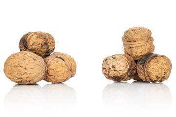 Lot of whole fresh brown walnut two heaps isolated on white background