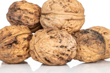 Lot of whole fresh brown walnut heap isolated on white background