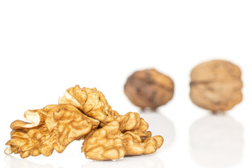 Group of two whole three pieces of fresh brown walnut front focus isolated on white background