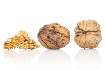 Group of two whole three pieces of fresh brown walnut isolated on white background