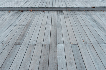 The texture of the flooring from wooden boards. Background of a street scene from wooden planks. Wooden deck. Plank floor perspective podium.
