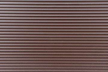 Brown horizontal blinds texture. Background of metal rolling shutters.