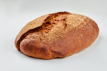 Loaf of traditional bread on white background. Loaf of rye bread.