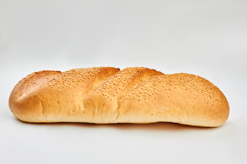 Fresh loaf of french bread and copy space. Freshly baked organic bread on white background.
