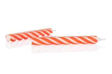 Fototapeta premium Group of two whole orange birthday cake candle isolated on white background