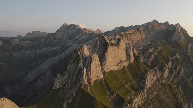  Aerial shot of big vertical rock wall above the mountain valley.  Bird eye view.