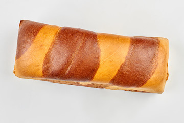 White and brown bread loaf, top view. Fresh two-color bread isolated on white background.