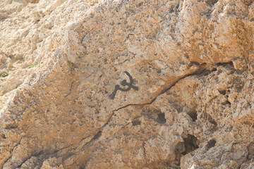 Black sign of the Soviet Union painted on an old stone rock