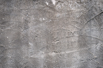 Gray concrete wall texture painted with white. The old white color that has been fading and peeling off. Texture of old dirty concrete wall for background.