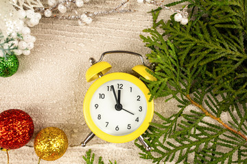 Christmas background with alarm clock, pine tree branch and copy space