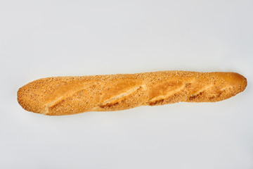 Long french baguette, top view. Loaf of french bread with sesame seeds. Space for text.