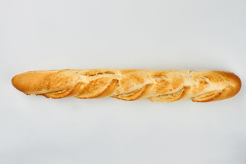 Long french baguette on white background. Crispy french bread, top view. Space for text.