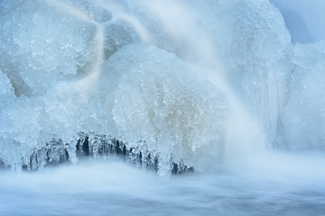 Winter landscape of the Rabbit River cascade encased in ice, Michigan, USA