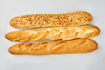 Three long baguettes on white background. Easy homemade french bread.