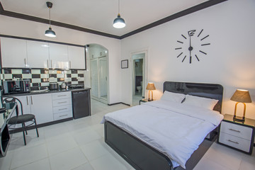 Fototapeta na wymiar Interior design of bedroom in studio apartment with kitchen