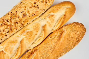 Three french baguettes on white background. Different french baguettes. Delicious homemade bread.