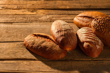 Artisan bread on wooden background. Wholemeal wheat bread. Homemade bread recipe.