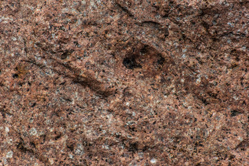 Old rough uneven red stone wall