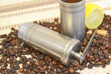 Vintage manual coffee grinder with roasted coffee beans