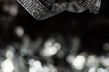 Abstract monochrome background with festive ribbon and bokeh