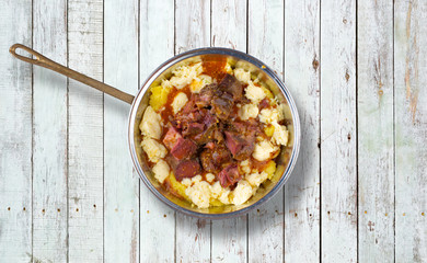 Baked sheep meat with polenta and cheese.