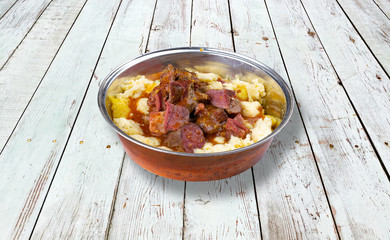 Baked sheep meat with polenta and cheese.