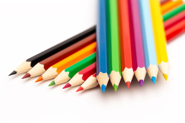 Wooden colored pencils of different colors on a white background
