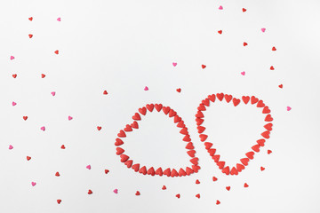 Heart made with heart candy of different colors on a white background.