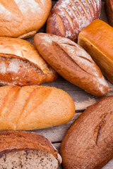 Healthy bread pile, top view. Different types of bread. Healthy homemade flour product.